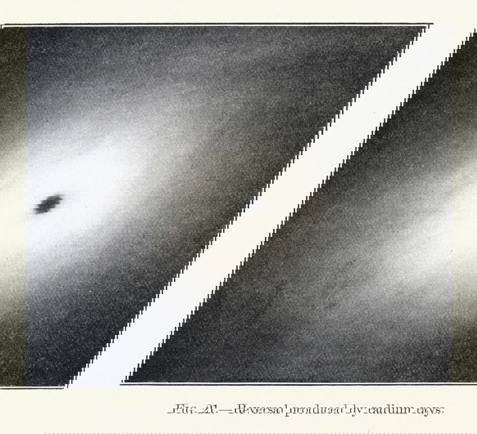 An image of a small pinpoint of black surrounded by white demonstrating “photographic reversal” through prolonged exposure to radium